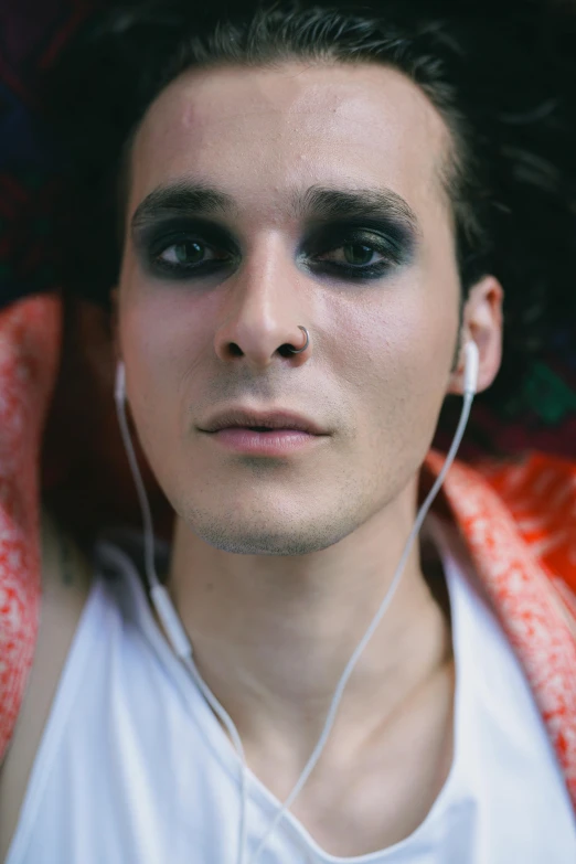 a man with a ear device in his head and a shirt with flowers