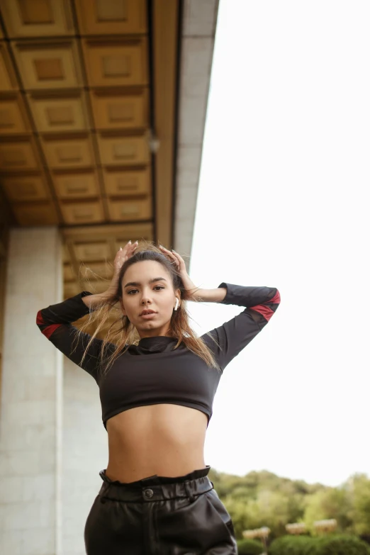 a woman posing in front of a tall building