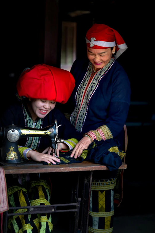 a woman in an elaborate dress working with a sewing machine