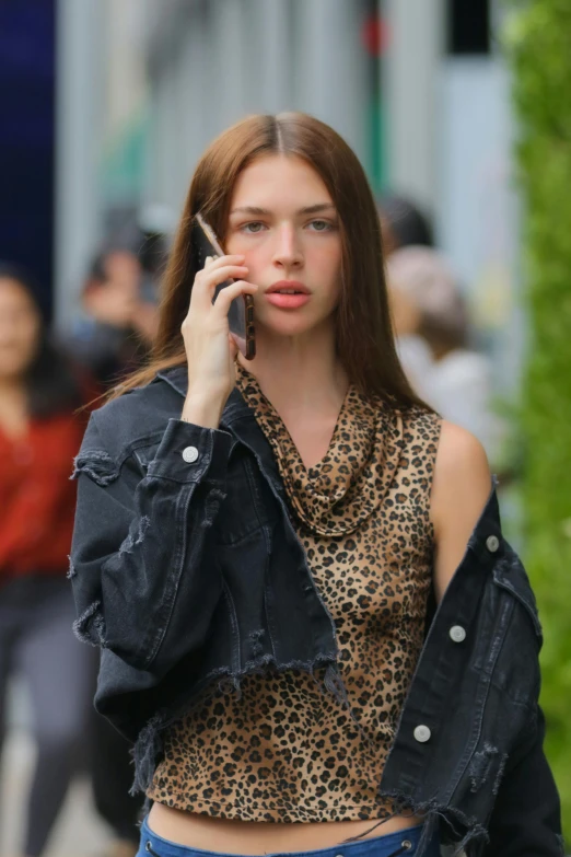 the young woman is talking on her cell phone