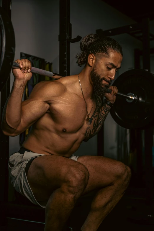 a shirtless man lifting his hand on the bar