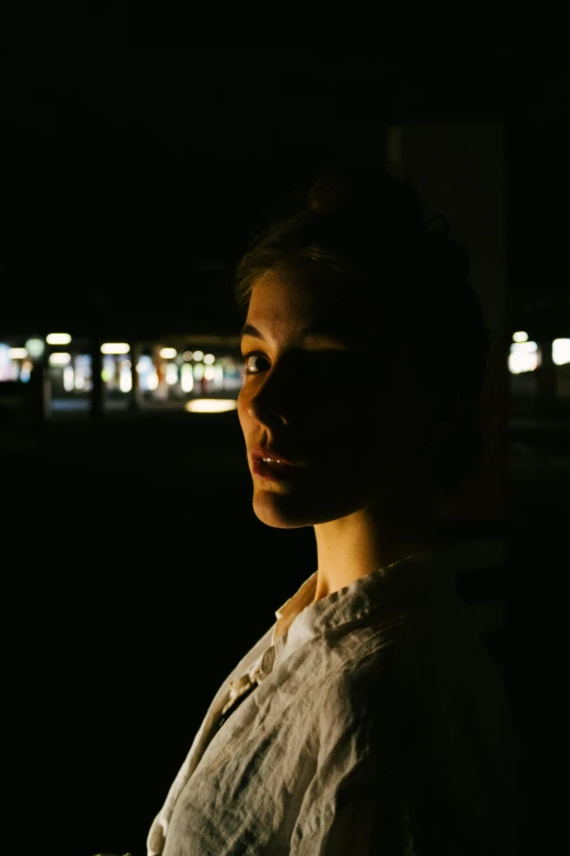 woman standing in front of window at night