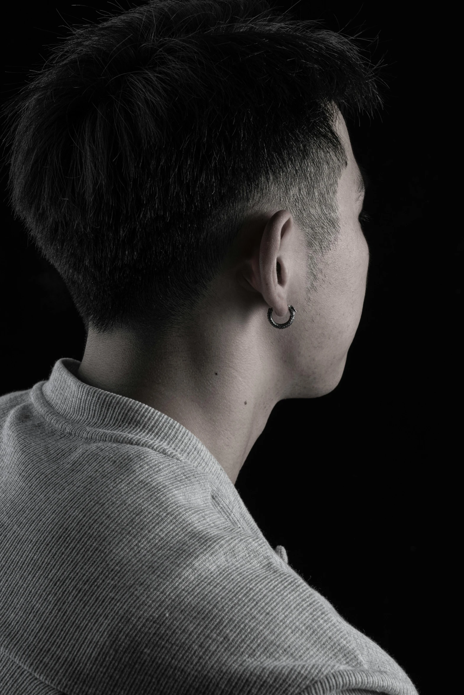 woman's profile on a black background with small tattoos