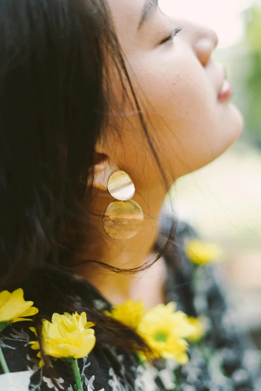 a woman wearing a black shirt with yellow flowers