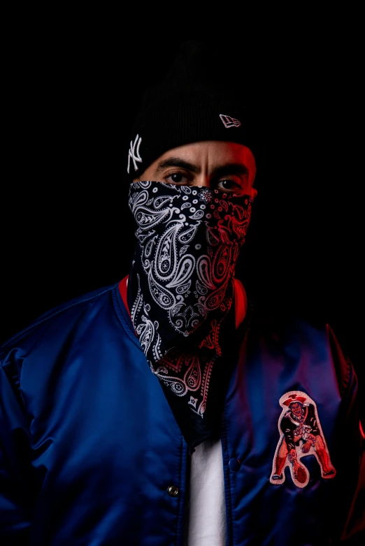 a man in an ornate bandana is posed for a po