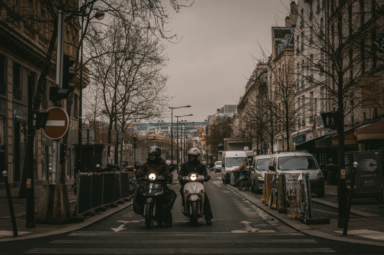 motorcycles are driving down an empty street