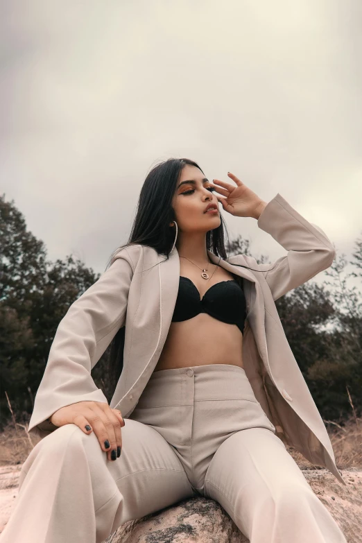 the woman is posing with her lips open and wearing an elegant suit