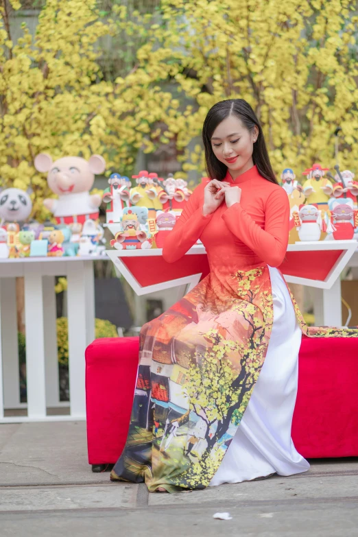 a woman in a red shirt is standing by a table covered in decorations