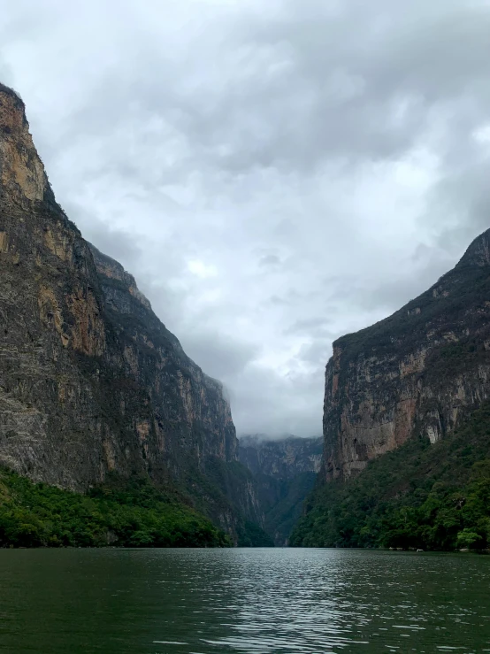 two mountains rise up from a calm body of water