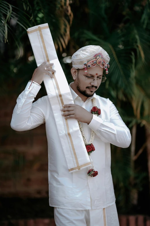 a man with a beard and white clothing