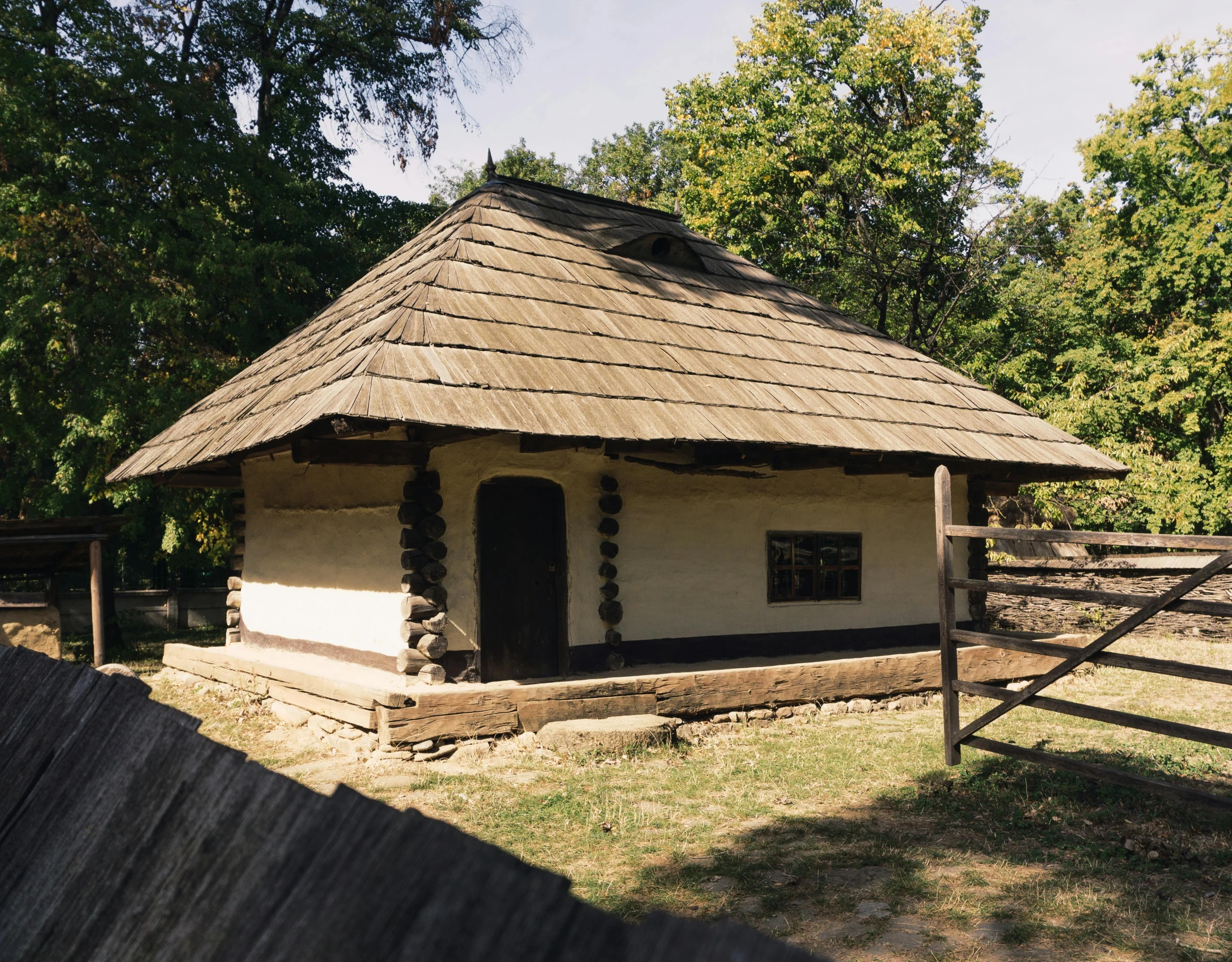 an old style building with grass and a gate