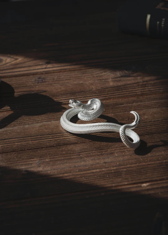 white rope sitting on top of a wooden table