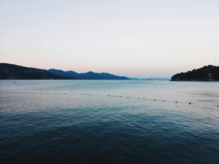 a boat is floating down the water by some small islands