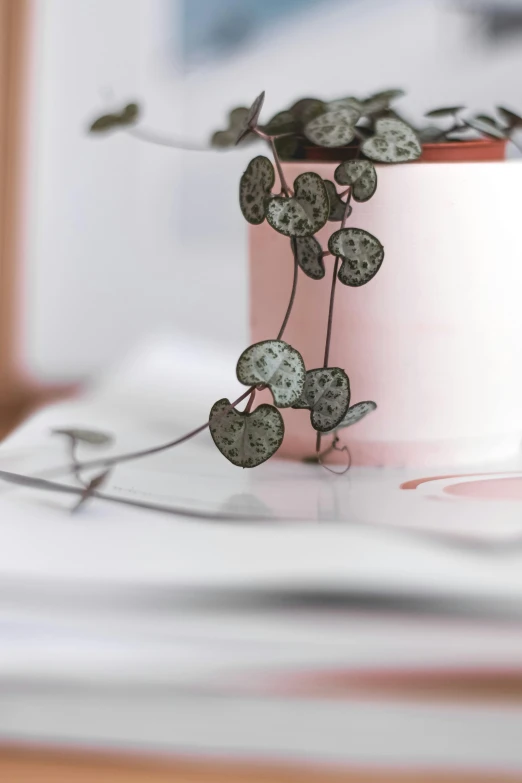 a close up of a metal object with flowers on a table