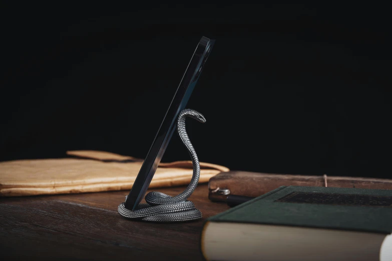 an unusual metal sword and some books on a table