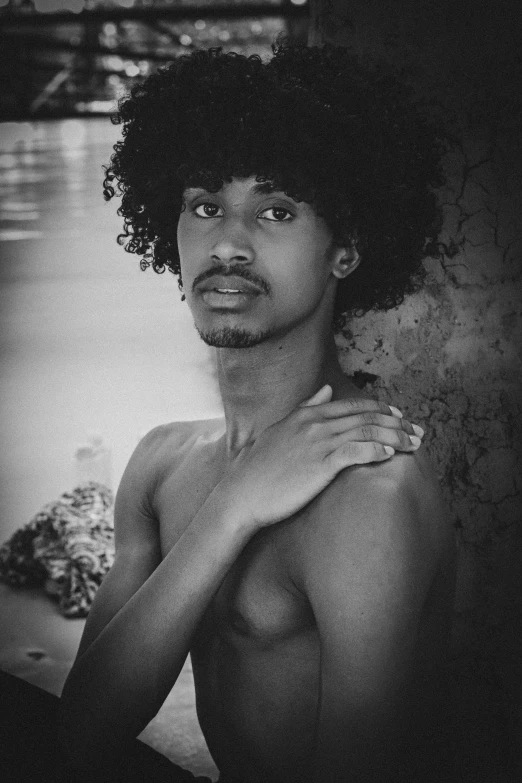 shirtless man with black hair is posing for the camera