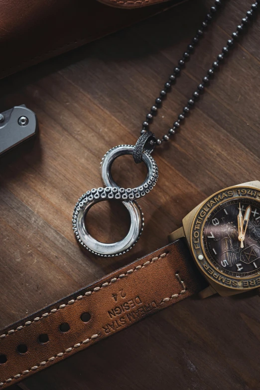 two watches are sitting on top of a wood table