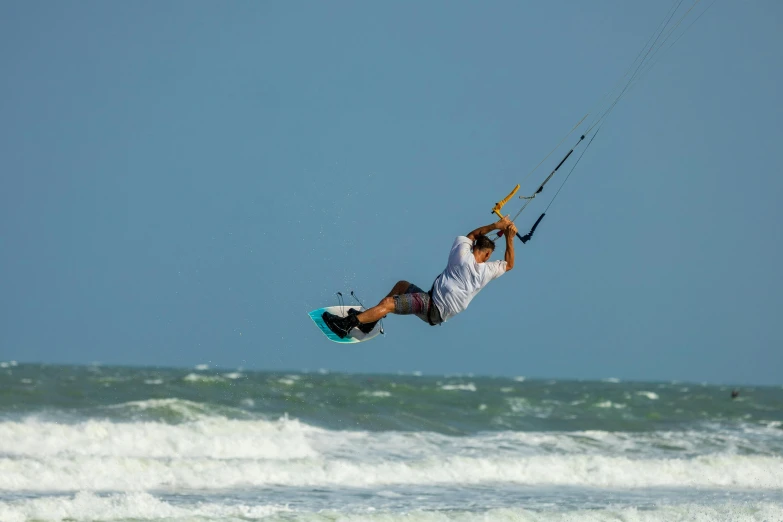 the person is having some fun on his kiteboard