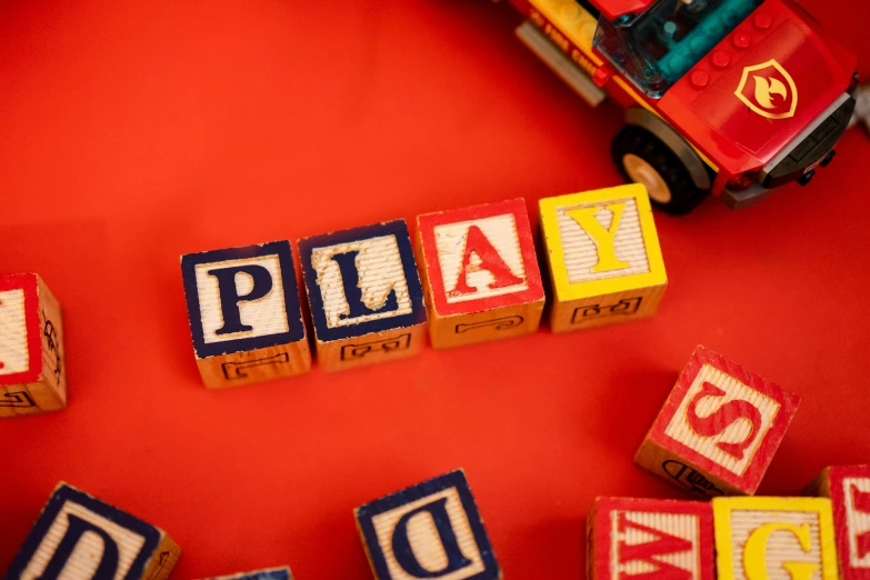 the word play spelled out of toy blocks