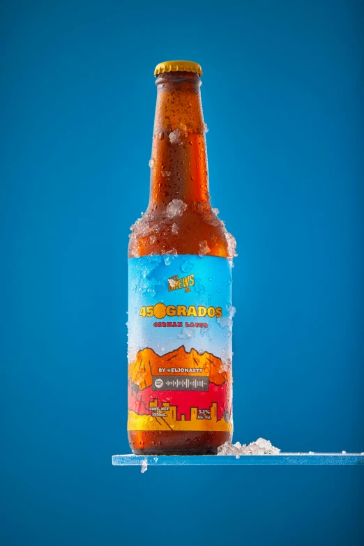 a bottle of beer sitting in the middle of snow