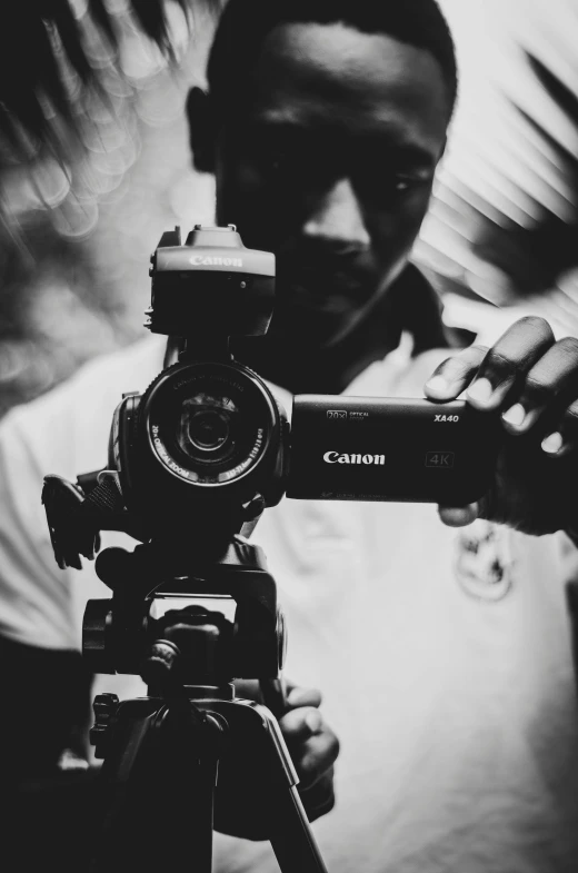 a black and white po of a man holding a video camera