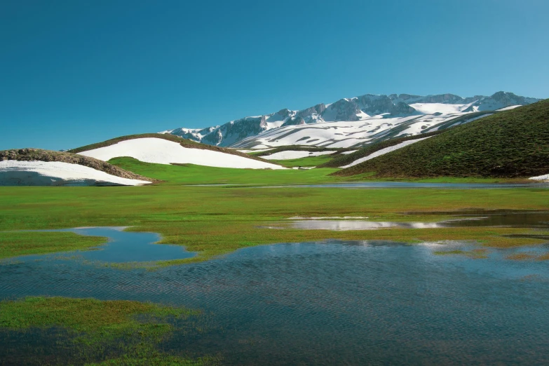 a field with some white snow on top of it