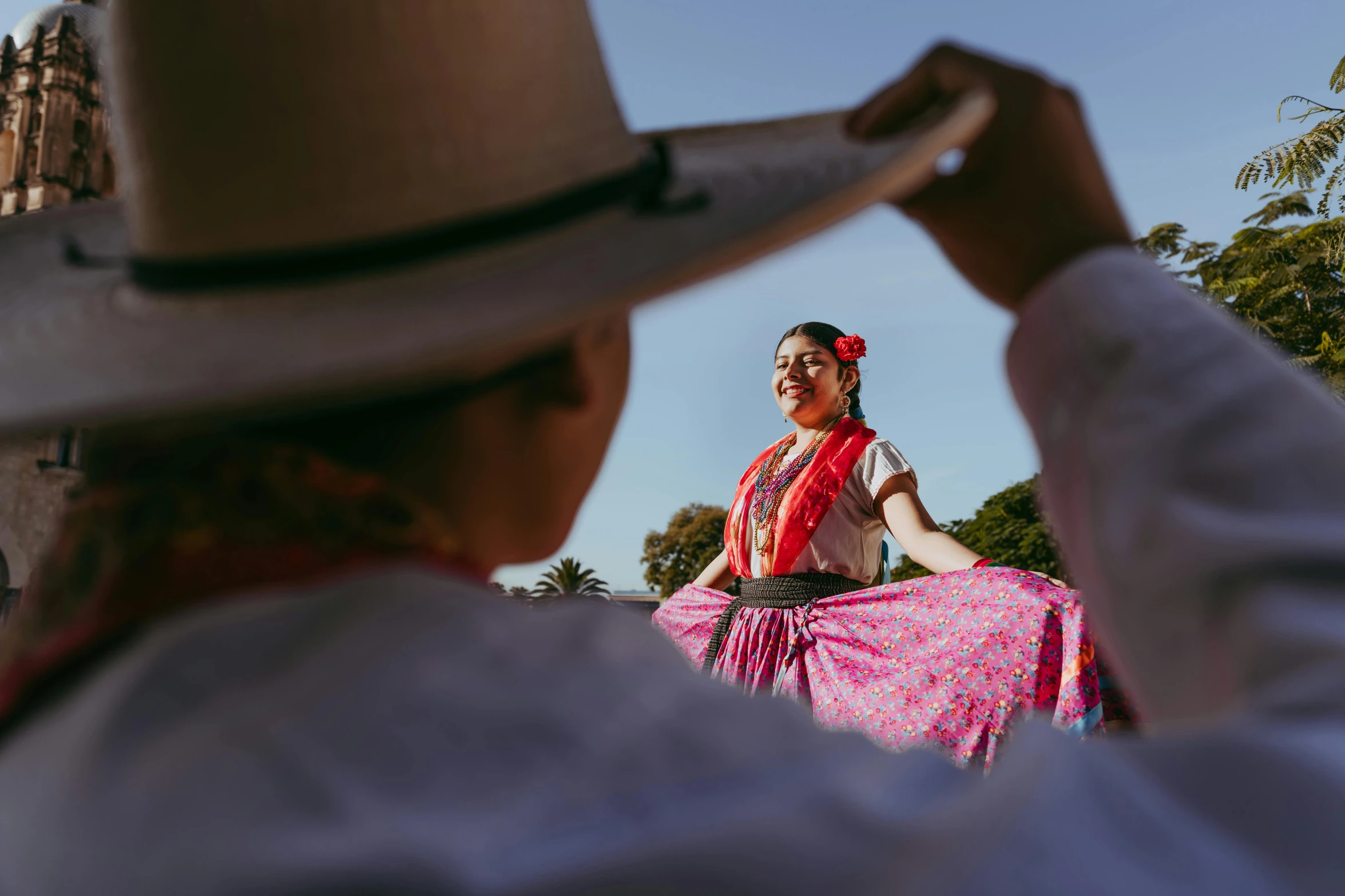 a woman is in an old mexican attire saluting