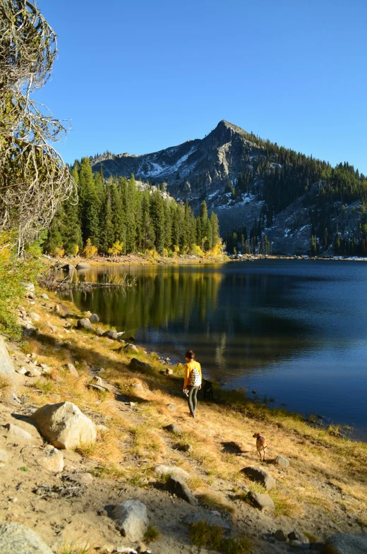 the mountains are reflected in the calm water