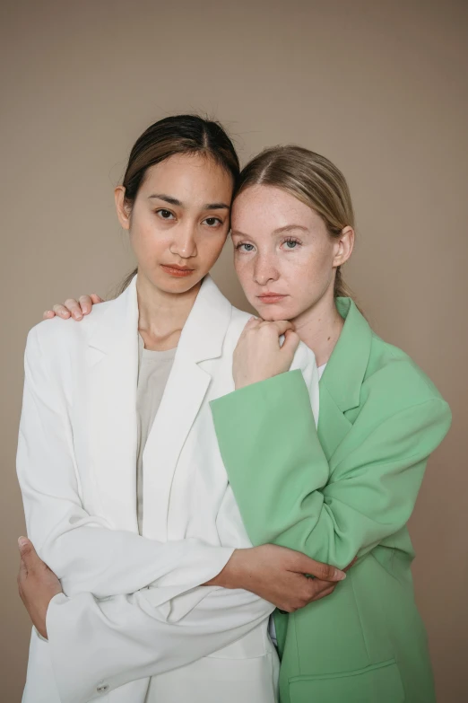 two beautiful young women standing next to each other