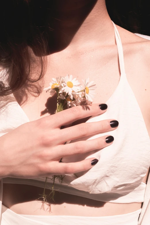 the woman's hand has a flower attached to it