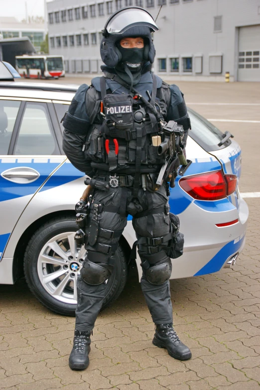 a police officer standing next to his car in front of him