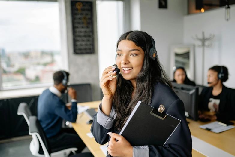 a girl talking on a phone in a call center