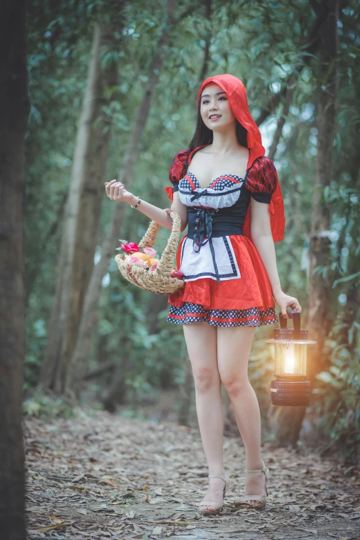 woman in traditional costume with red hair walking through forest