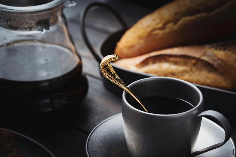 a small metal cup that is sitting on a saucer