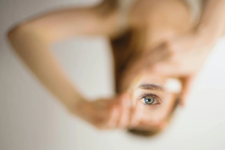 a  looking into a round mirror