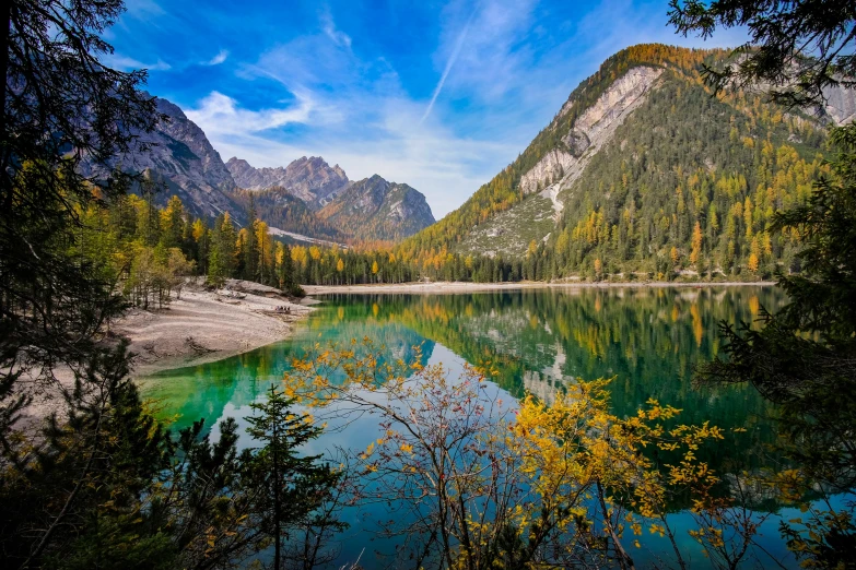 a river in the mountains with some trees around it