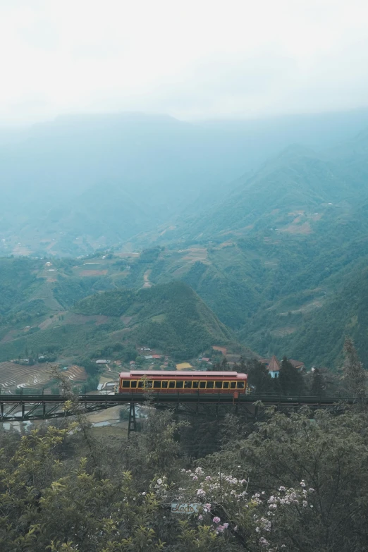 a red and yellow train traveling over a bridge