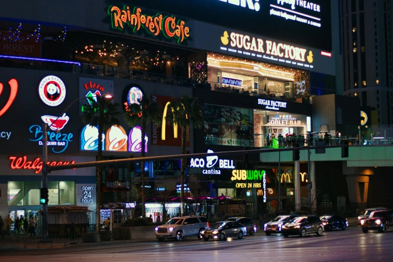 a city street filled with lots of cars at night