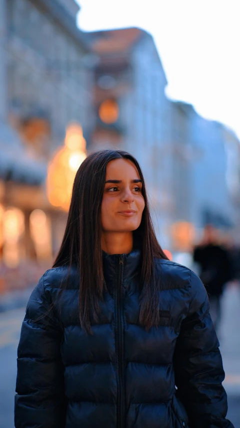 a woman is standing on the street while holding her jacket open