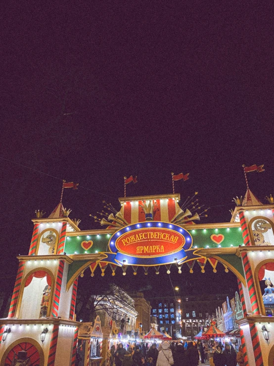 there are several people in front of a large circus sign