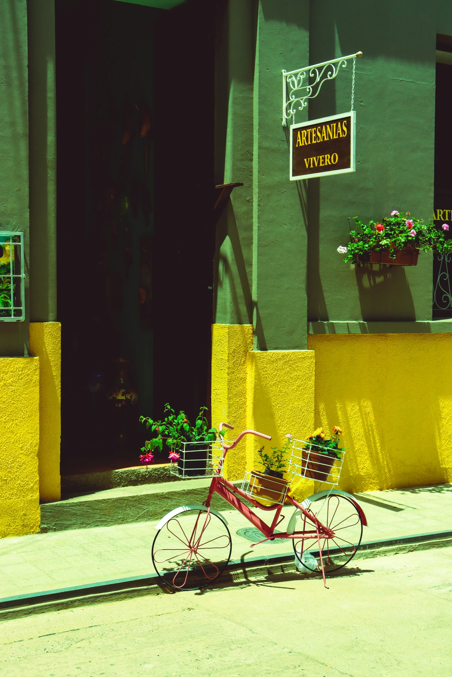 a red bicycle is parked outside a building