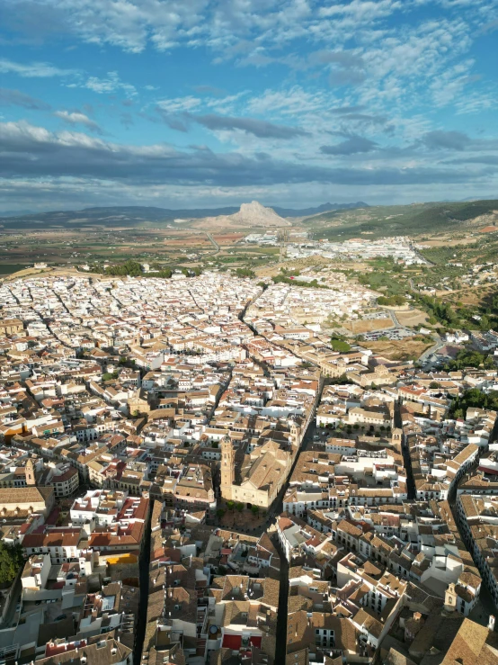 a city in the distance with a mountain behind it