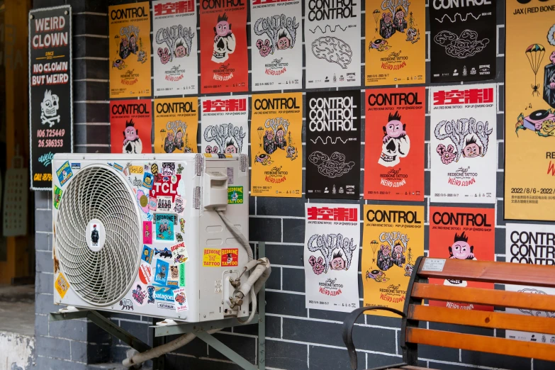 a wall covered with posters and a wooden bench