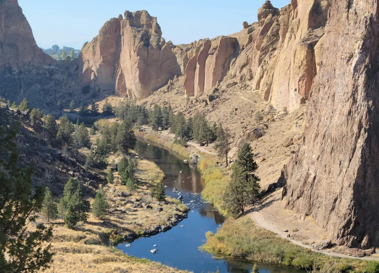 a river surrounded by tall hills and trees