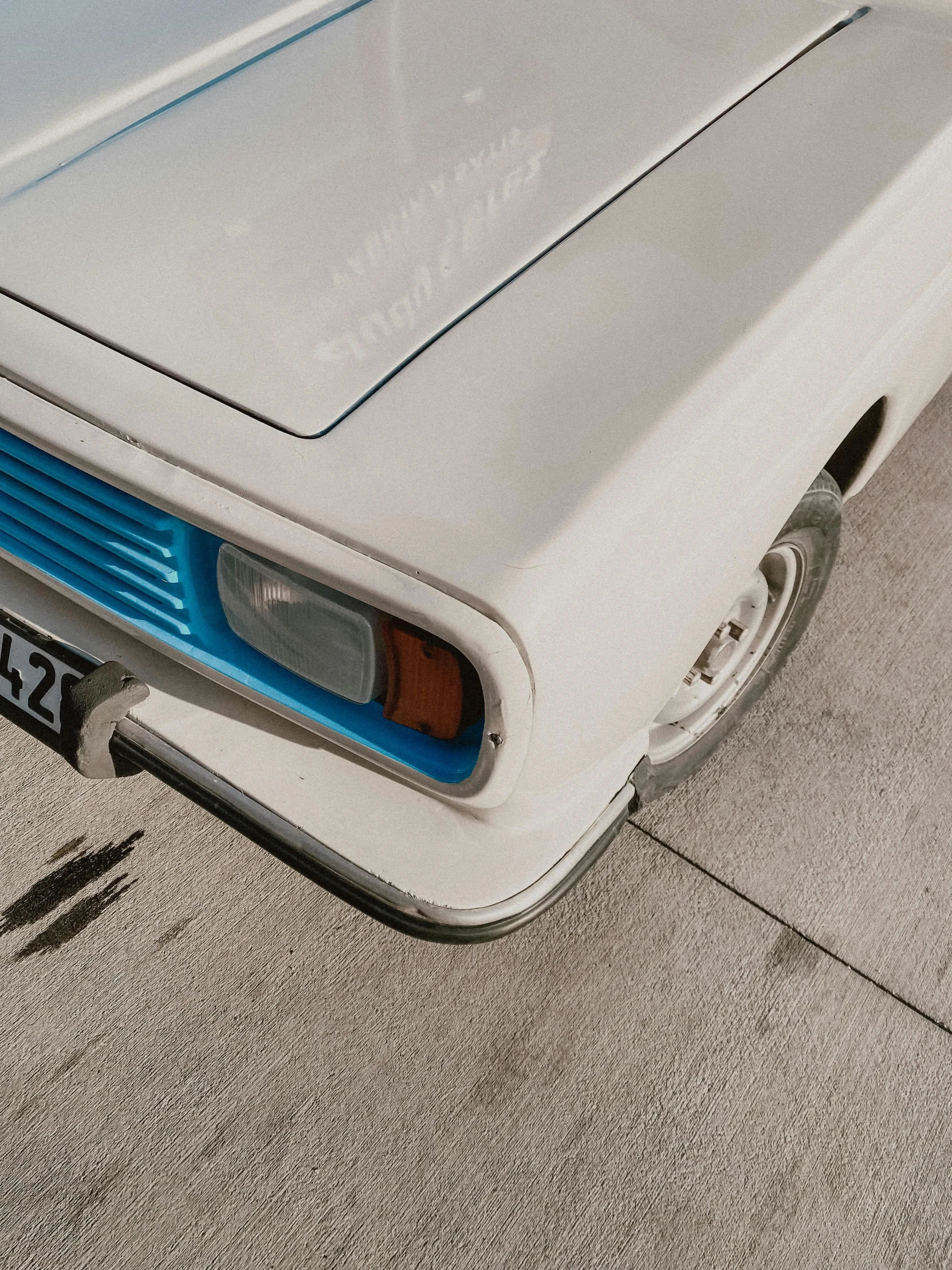 an old style classic car parked in a parking lot