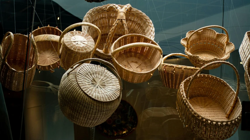 woven basket of various shapes hanging on a display wall