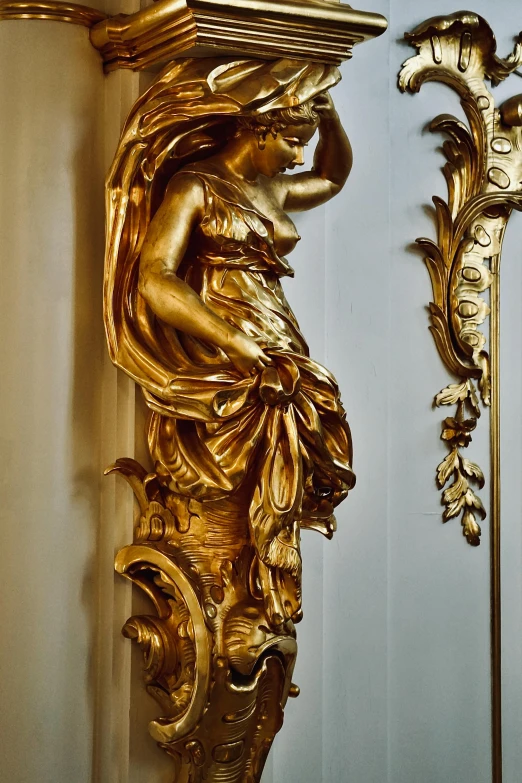 gold wall sculptures with ornate gilded trim and flowers