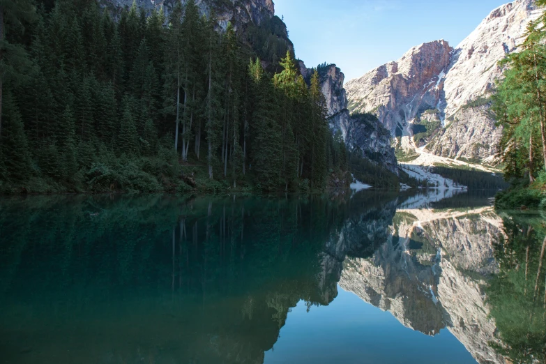 lake with reflection of mountains and trees in clear water