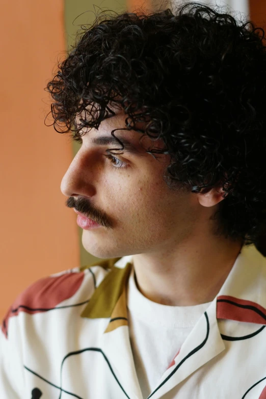 the close up view of a man with curly hair