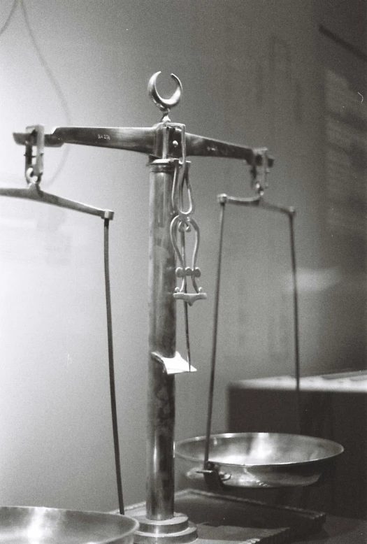 an old po of a scales with a sword on each scale